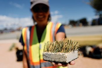 Candice Thompson, project manager with Winters Construction, displays a sample of HydroTurf Tuesday in Bloomfield. (Jon Austria — The Daily Times)